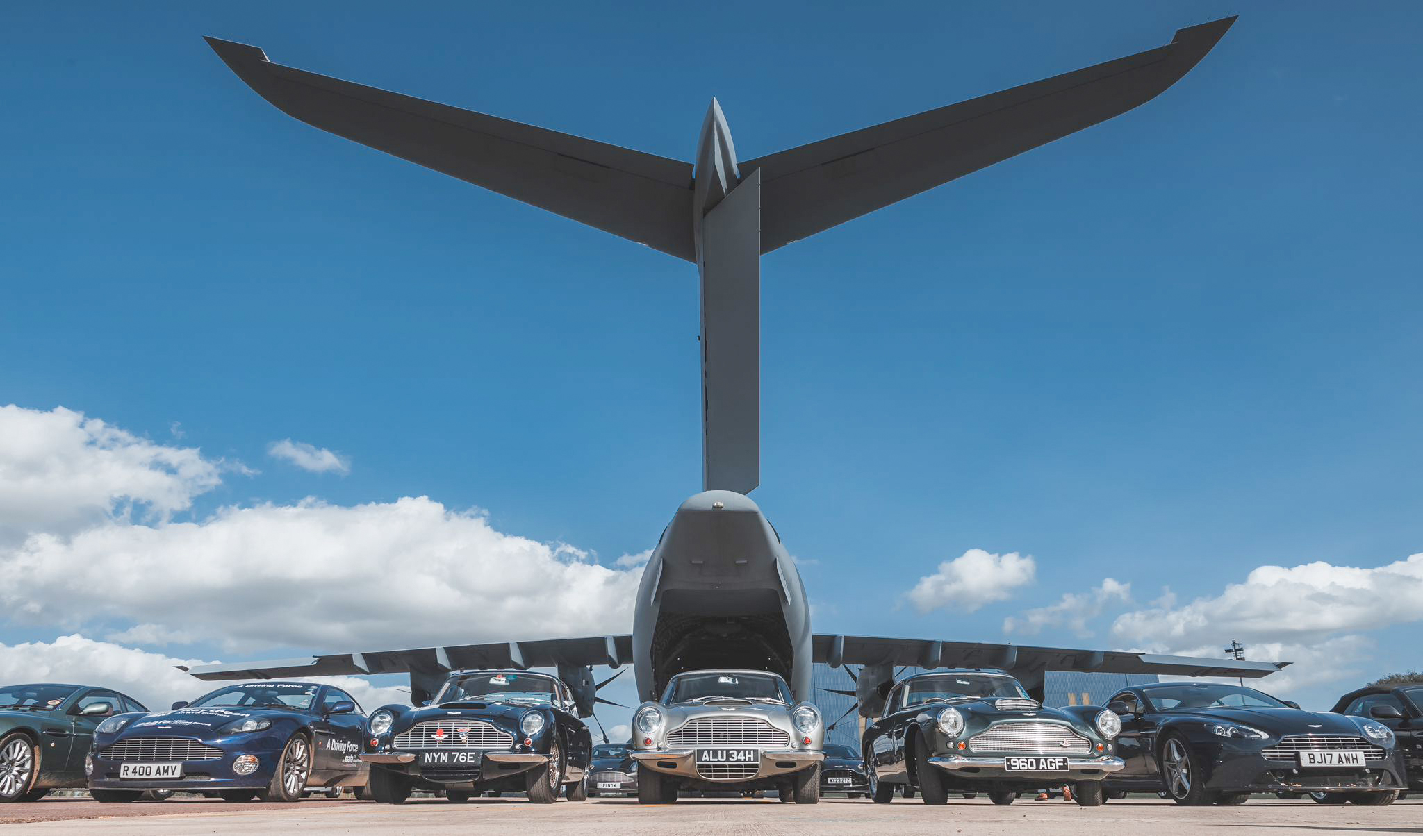 Photo - Aston Martin vehicles lined-up behind an Atlas C Mk.1 (A400M)